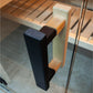 Nordik indoor sauna door handle with black metal pull and natural wood accents mounted on glass door