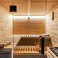 Almost Heaven Nordik indoor sauna with light wood interior, tiered benches, glass door, and heater visible on right side
