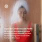 Woman in white towel and red top in steamy sauna with wet glass door, promoting cardiovascular health benefits