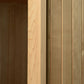 Wood sauna interior showing dark and light wood finishes with vertical paneling in flat lay