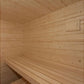 Interior view of wooden sauna with light pine walls, bench seating, and vented ceiling