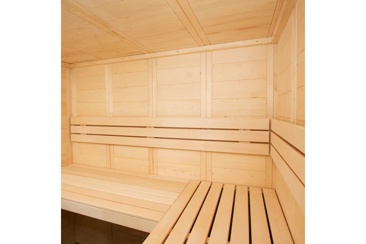 Interior view of light wood sauna with bench seating, backrest, and wooden ceiling