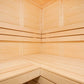 Interior view of wooden sauna with light pine benches and walls, corner seating arrangement