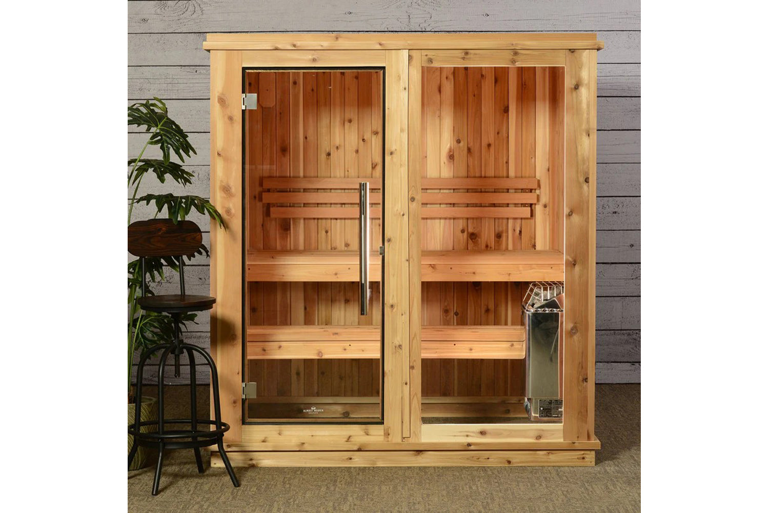 Almost Heaven Rainelle 4-person indoor sauna in light cedar wood with glass doors, wooden benches, and metal handles on gray 