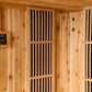 Cedar wood sauna interior with digital temperature controls, vertical black slat vents, and wooden benches with ventilation h