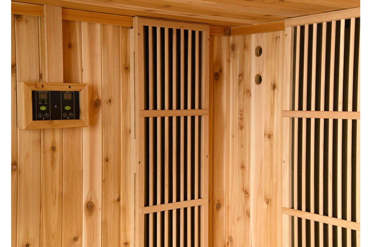 Cedar wood sauna interior with digital temperature controls, vertical black slat vents, and wooden benches with ventilation h