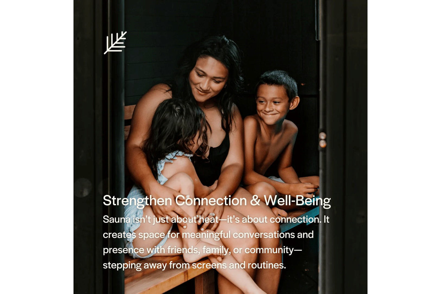 Woman and two children sitting together in wooden sauna with dark interior walls