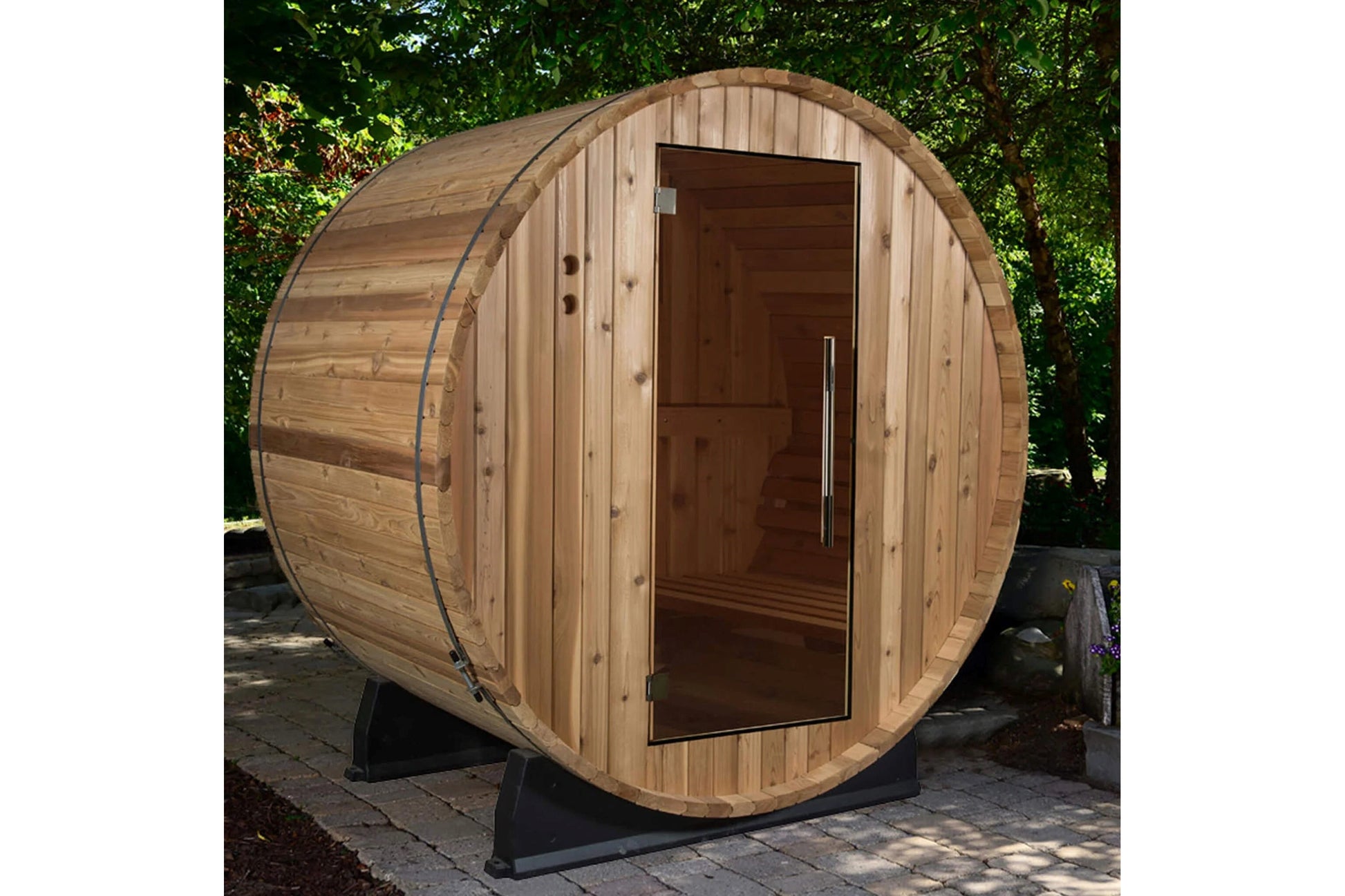 Wooden barrel sauna with natural light wood finish, dark wood door with metal handle, mounted on black metal support frame in
