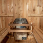 Cedar barrel sauna interior with tiered wooden benches, stainless steel heater with rocks, and control panel on floor