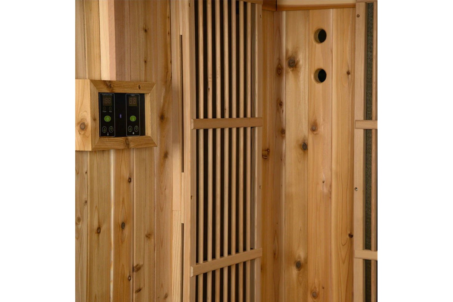 Natural wood sauna interior with vertical cedar slats, digital control panel with green buttons on left wall, and ventilation