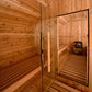Almost Heaven Shenandoah 4-person barrel sauna interior with wooden benches, glass door with black frame, and wood-burning st