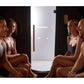 Four people relaxing inside a wooden barrel sauna with glass door and black interior walls
