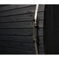 Black wood barrel sauna exterior with horizontal shiplap siding and metal straps with silver buckle closures