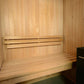 Natural wood interior of Almost Heaven Spectacle 2-person sauna with tiered seating, backrest, and black Harvia heater on rig