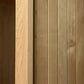 Almost Heaven Spectacle 2-person indoor sauna with light and dark wood paneling, showing hybrid wood construction on white ba