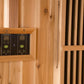 Dual digital control panels with temperature displays mounted in wooden frame on sauna wall