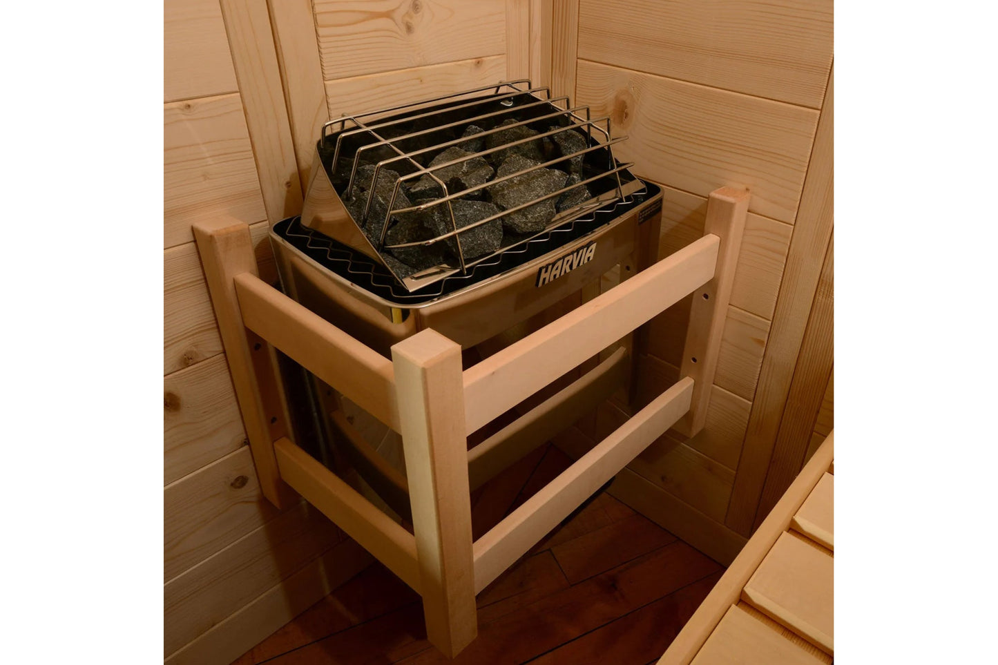 Harvia sauna heater with black metal grate basket filled with stones, mounted inside wooden sauna interior