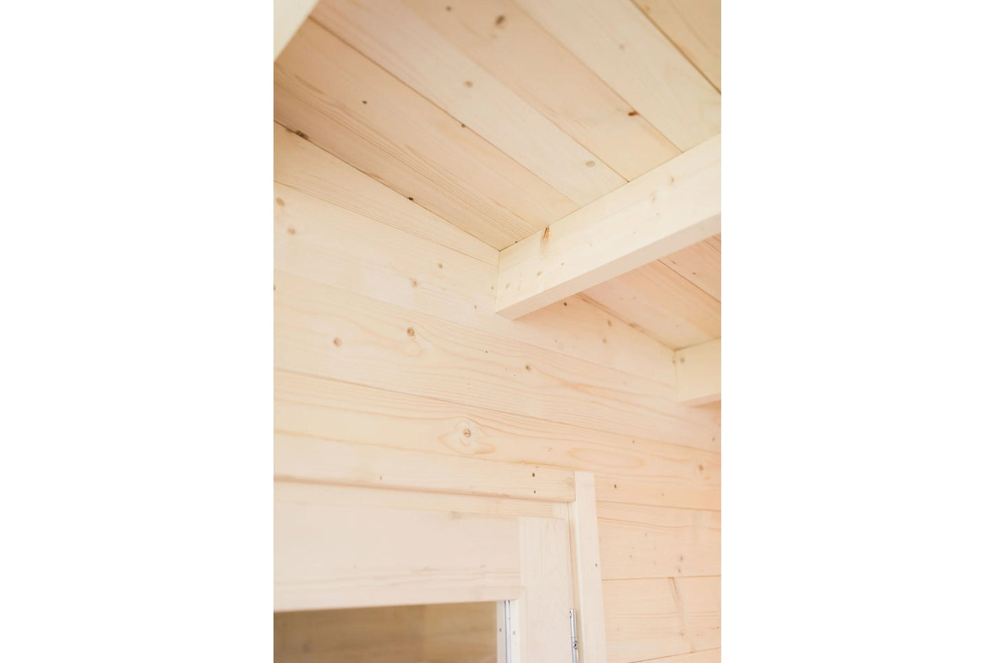 Interior view of wooden sauna ceiling and walls with exposed pine beams and horizontal wood paneling