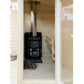 Black wood-burning sauna stove with chimney inside light wood sauna cabin interior