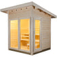Natural wood outdoor sauna with glass door and window panels, illuminated interior showing wooden benches and light-colored p