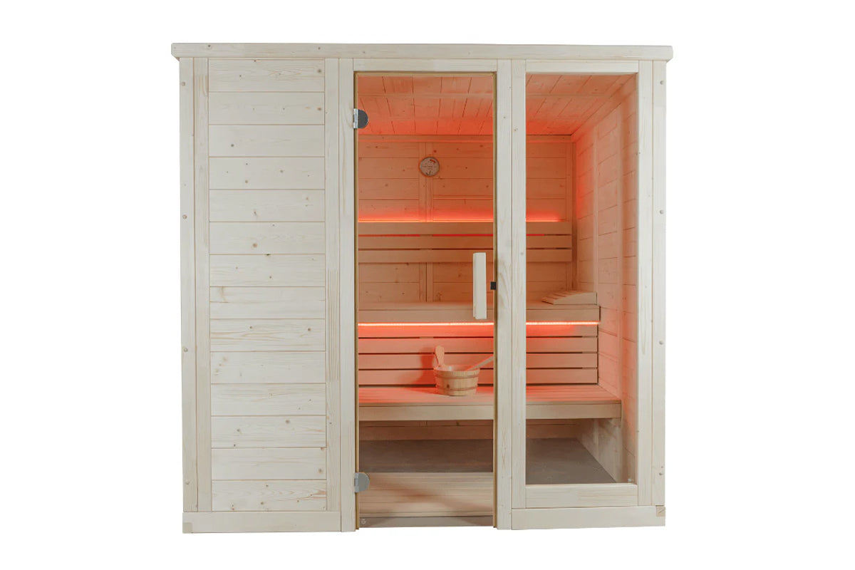 Natural pine wood sauna cabin with glass door, red cedar interior with lit red heating elements, benches, and wooden bucket v