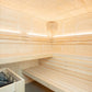 Interior view of light wood sauna with built-in benches, wooden paneled walls, LED lighting, and heated stone basin