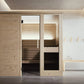 Light wood sauna with glass and wood panel doors, featuring interior wooden benches and dark lower panels, positioned in mode