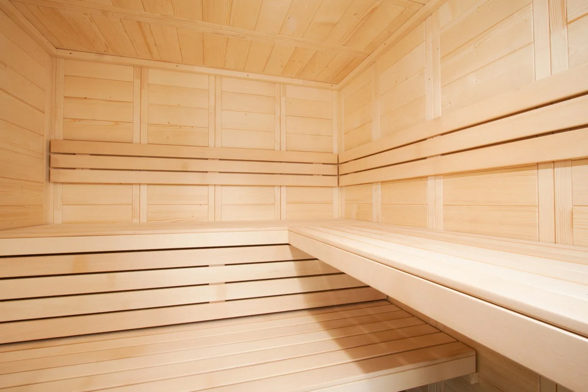Almost Heaven Worthington sauna interior with light wood paneling, tiered benches, and vaulted ceiling