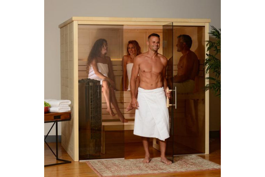 Almost Heaven Worthington indoor sauna with light wood frame, glass doors, and multiple people inside on wooden benches