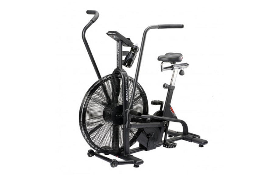 Black air bike with large fan wheel, dual handles, padded seat, and foot pedals on white background