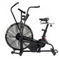 Black stationary exercise bike with oversized fan wheel, dual handlebars, and padded seat on white background
