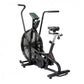 Black upright stationary air bike with large fan wheel, digital display console, and adjustable seat on white background