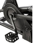 Black exercise air bike with large fan wheel, handlebars, and foot pedals on white background