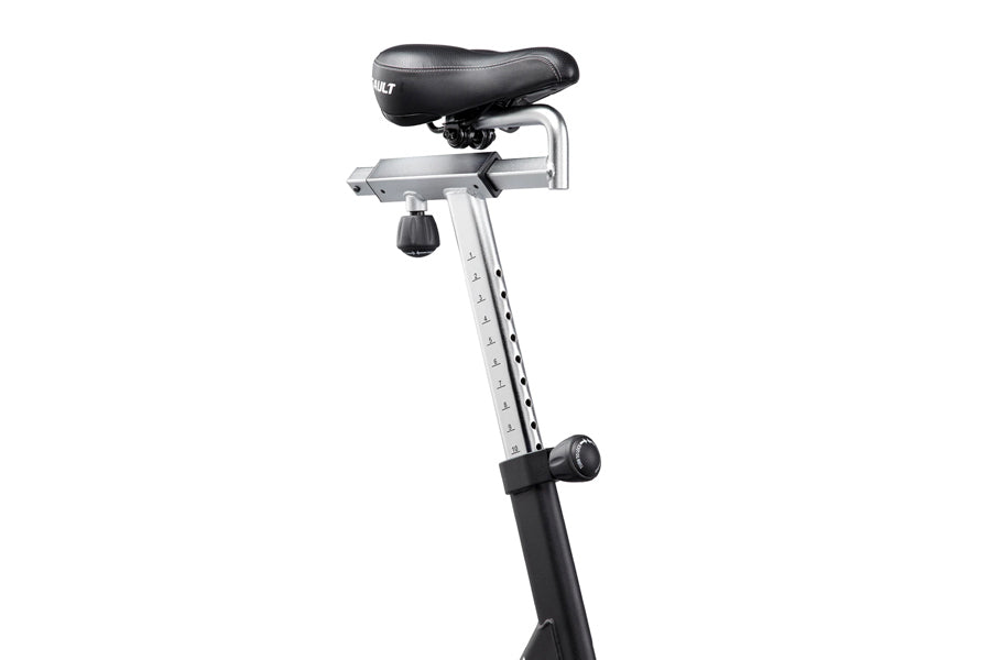 Stationary exercise bike with black padded seat, silver metal frame, black pedal post, and adjustment knob on white backgroun