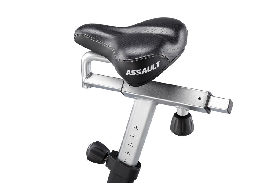 Assault AirBike stationary exercise bike with black padded seat, silver frame, and adjustment knob on white background