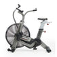Assault Elite Air Bike with silver frame, large black fan wheel, dual handlebars, and black padded seat on white background