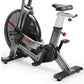 Assault Fitness Elite air bike with black mesh fan wheel, gray steel frame, black seat, and digital display on white backgrou