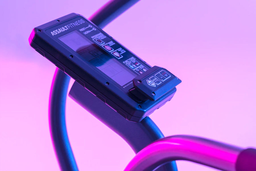 Assault Fitness Elite Air Bike console with digital display and control buttons mounted on purple and blue curved frame again