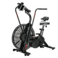 Black air bike exercise machine with large fan wheel, dual handles, and padded seat on white background