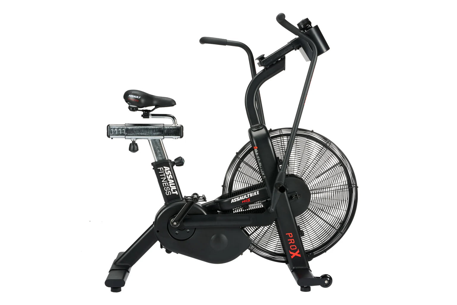 Black AssaultBike Pro X air bike with large fan wheel, curved handlebars, padded seat, and digital display on white backgroun