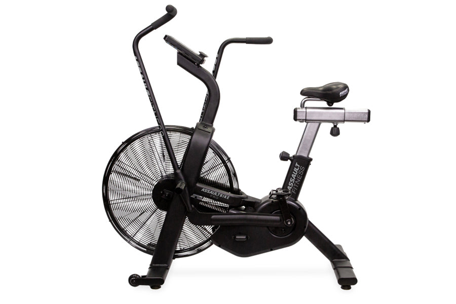 Black and gray stationary air bike with large fan wheel, curved handlebars, and padded seat on white background