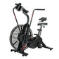 Black air bike with large fan wheel, upright handlebars, and stationary seat on white background
