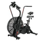 Black stationary air bike with large fan wheel, handlebars with phone holder mount, and padded seat on white background
