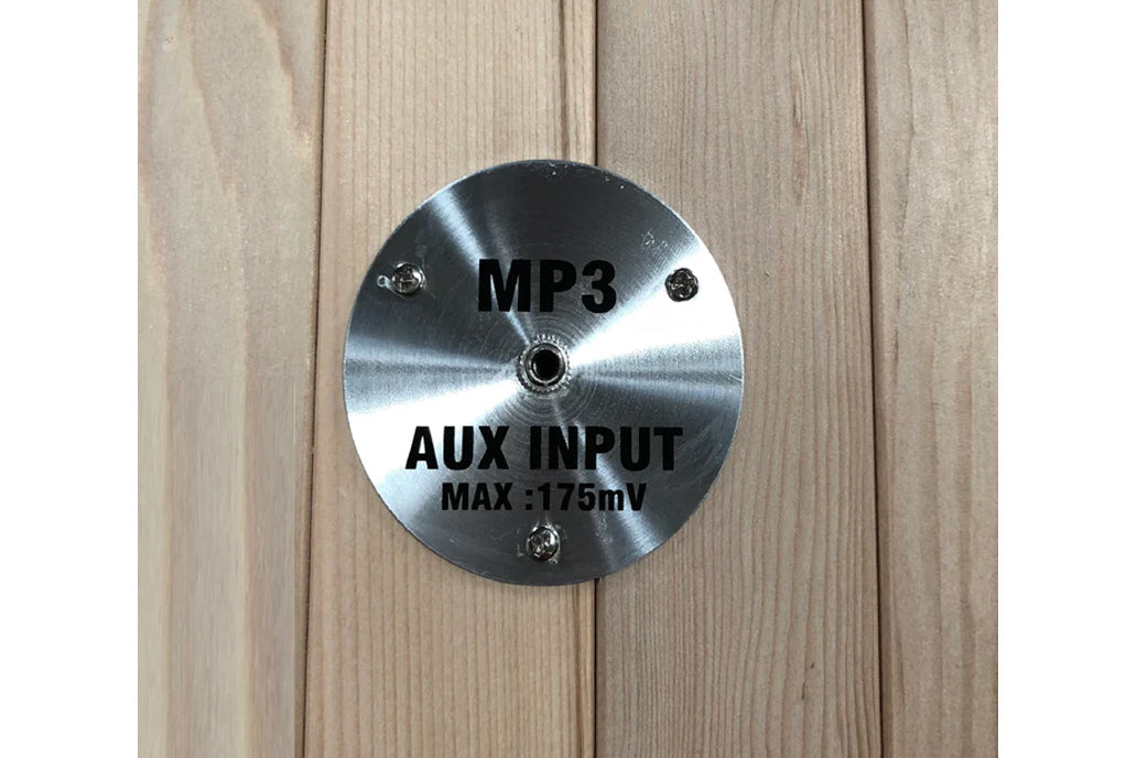 Brushed silver metal control panel with MP3 and AUX INPUT MAX 175mV text, mounted on light wood background