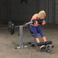 Woman performing ab exercise on gray and black Body-Solid Ab & Back Machine with weighted barbell in gym setting