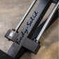 Body-Solid Compact Leg Press Hack Squat machine with black frame and chrome accents, flat lay on concrete surface