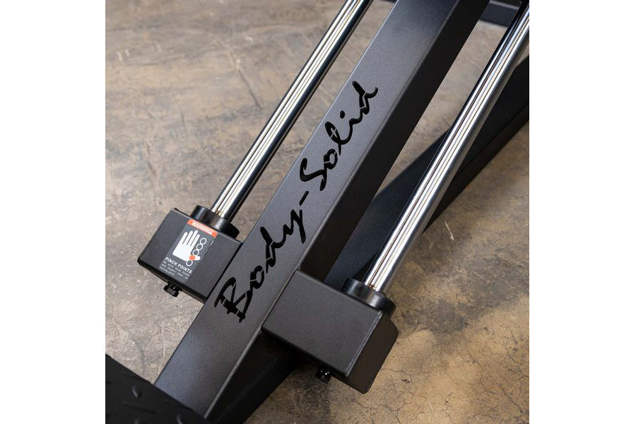 Body-Solid Compact Leg Press Hack Squat machine with black frame and chrome accents, flat lay on concrete surface