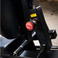 Black leg press machine with red "Roadbusy" brand knob and yellow warning label, close-up detail view