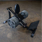 Body-Solid black compact leg press and hack squat machine with weight plates and adjustable seat on concrete floor
