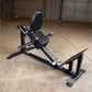 Black leg press and hack squat machine with padded seat and backrest, displayed in garage setting